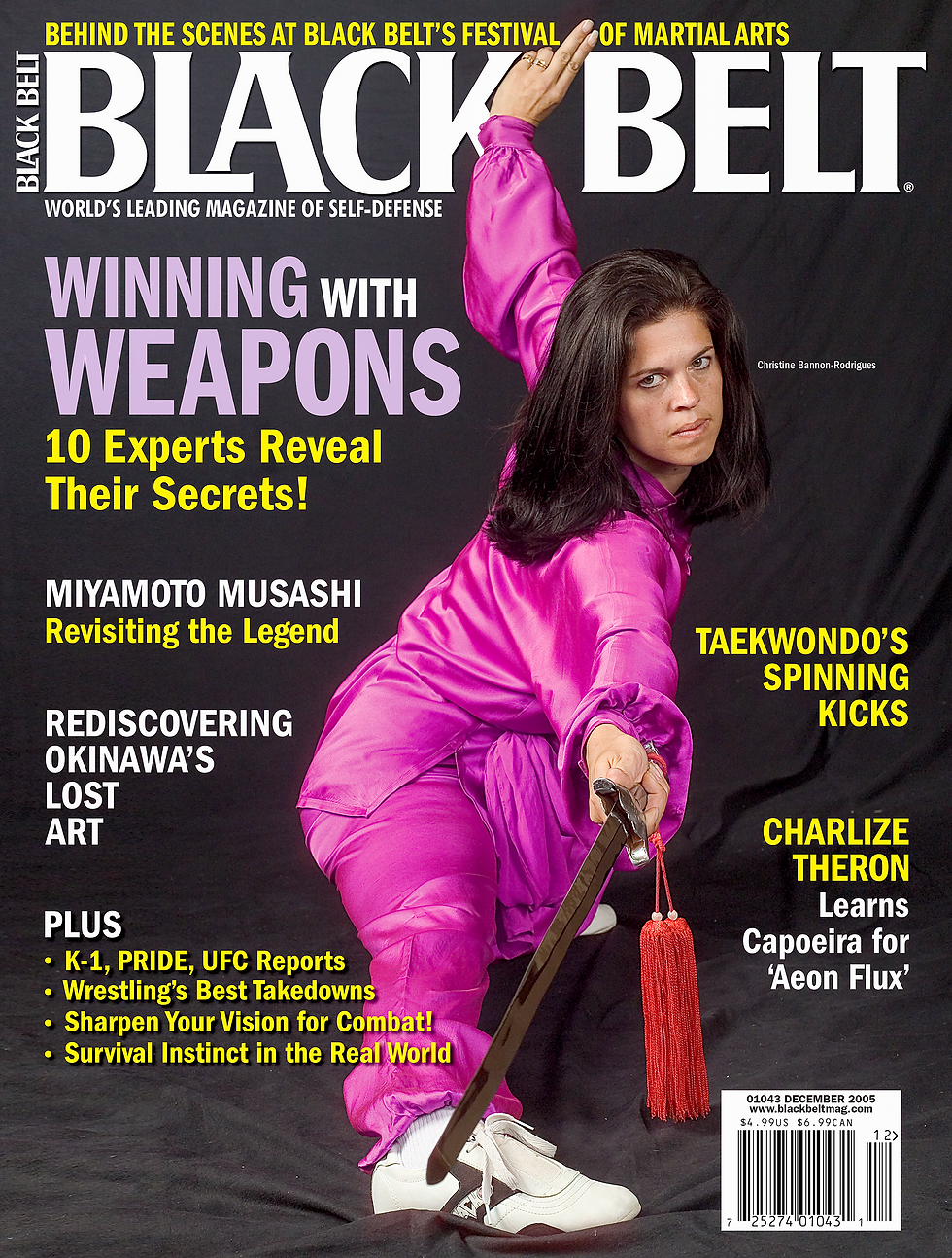 Martial artist in a pink outfit wields a sword on Black Belt magazine cover. Headlines feature self-defense tips and articles on martial arts.