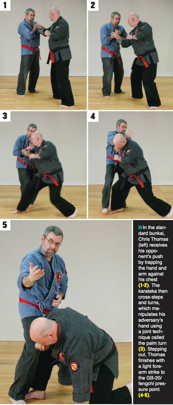 Two martial artists in blue and black uniforms demonstrate a defensive technique sequence in a dojo, involving joint manipulation. Text describes moves.