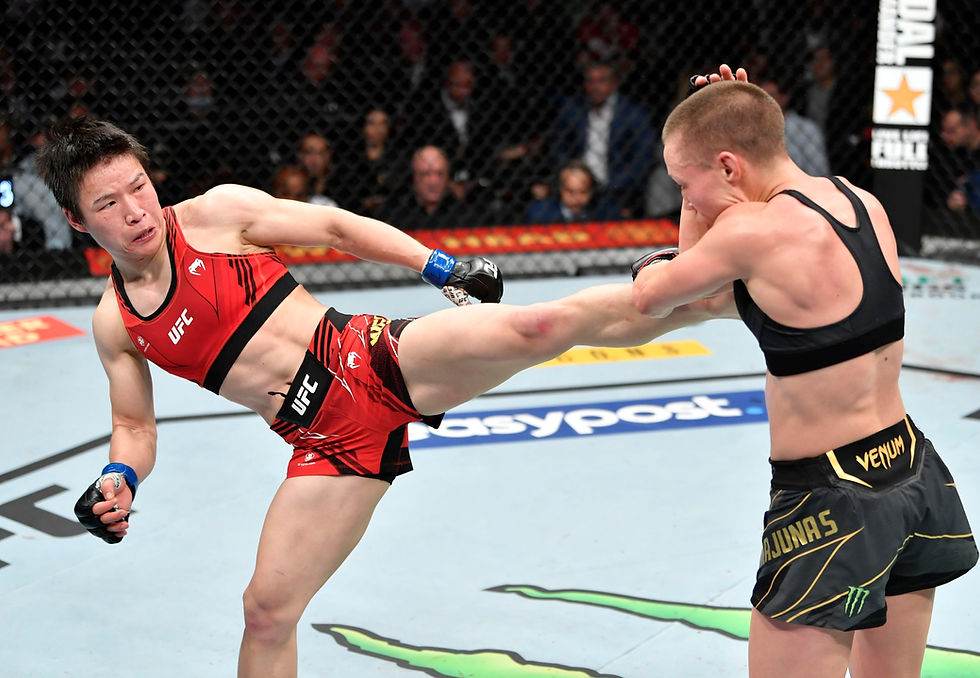 Two mixed martial artists in an intense UFC fight. One in red lands a high kick on the other in black. Octagon setting, focused crowd.