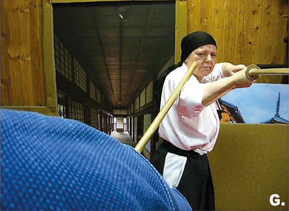G. However, the jo practitioner intercepts her action by maneuvering his weapon into position to stab her eye.