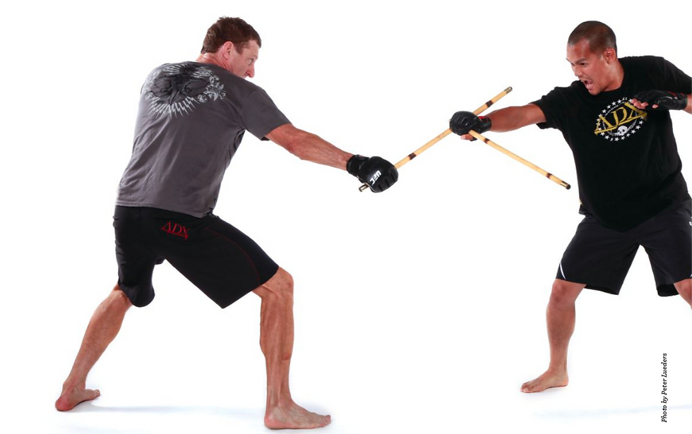 Paul Vunak faces off against an opponent in a stick fight