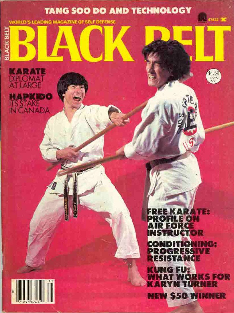 Black Belt magazine cover with two karate fighters sparring with staffs on a red background, bold yellow title and cover lines.