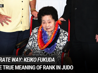 an elderly woman sits in a wheelchair escorted by two men