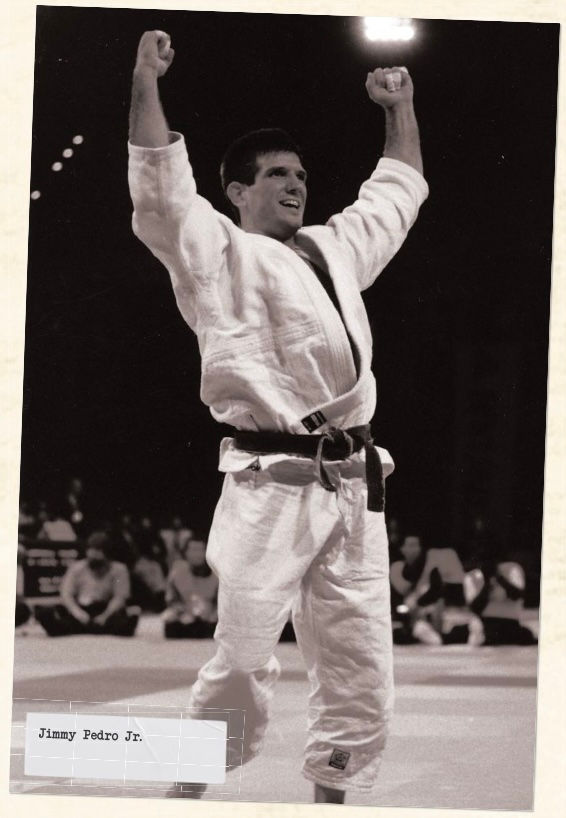 A judo athlete in a white gi celebrates with raised arms. He's on a mat with an audience in the background. Mood is triumphant. Text: "Jimmy Pedro Jr."