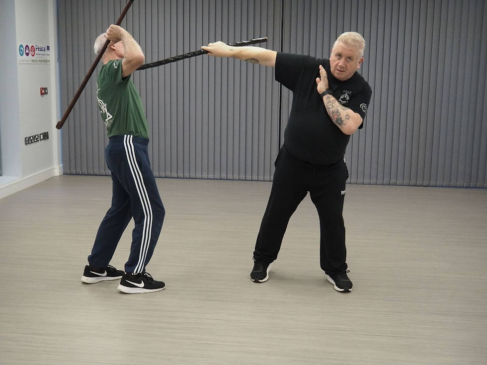 two men fighting with Irish sticks