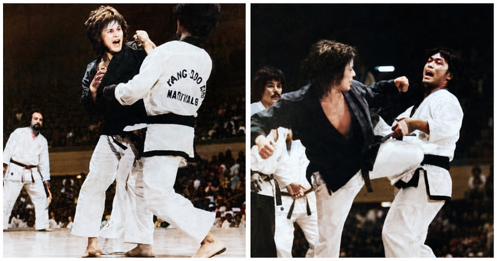 Martial arts sparring on a lit arena stage, with black- and white-clad fighters mid-strike and a crowd blurred in the background.