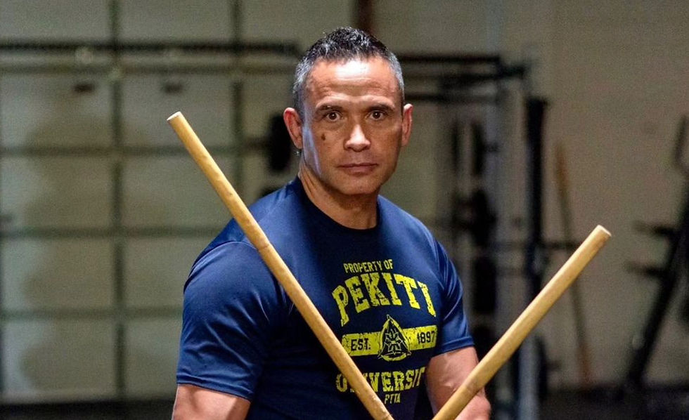 Jared Wihongi poses with two kali sticks